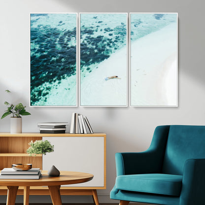 Canvas featuring an aerial view of a swimmer in shallow turquoise waters with coral patterns, ideal for tropical coastal home decor.