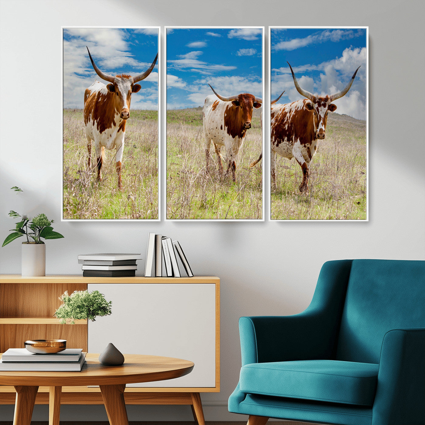 Three Texas longhorn cattle standing in dry grass under a bright blue sky, ideal for farmhouse or western rustic home decor.