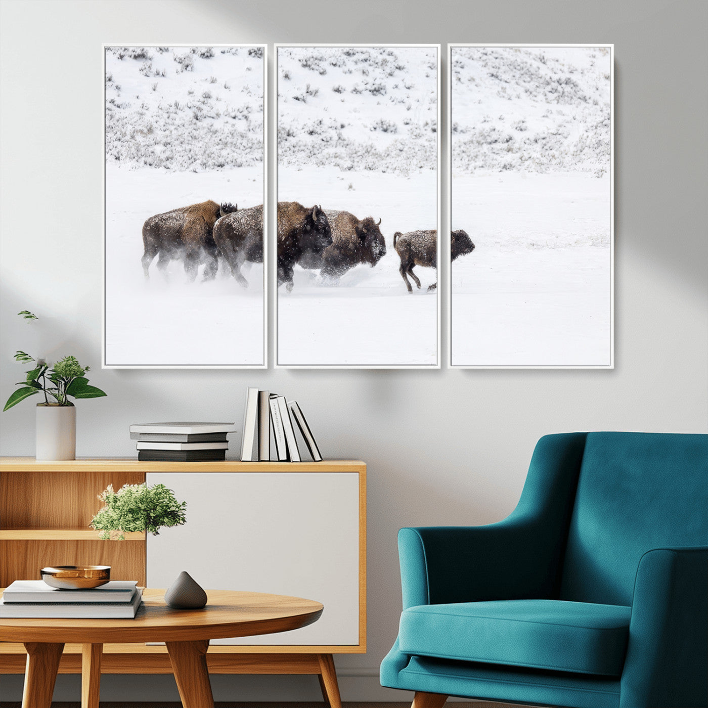 Bison herd running through a snowy open field with mountain backdrop, perfect for rustic or western-themed wall decoration.