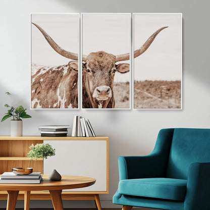A longhorn cow in soft beige desert tones, standing calmly in open land, perfect for neutral western or rustic farmhouse interiors.