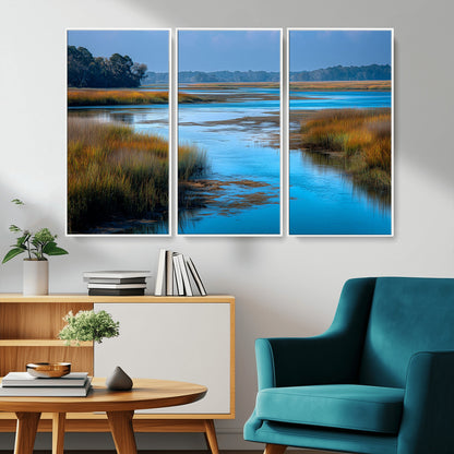 A peaceful marshland scene with calm blue water reflecting the surrounding grasses and trees, capturing the beauty of nature in a serene landscape.