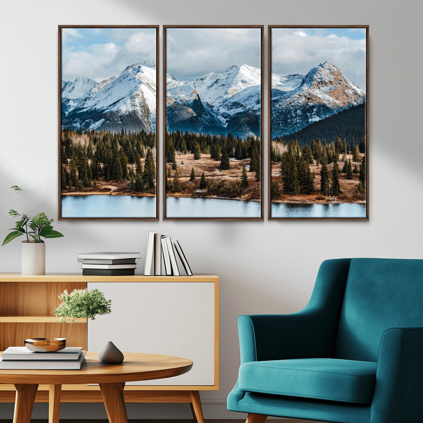 Framed canvas of snowy mountain peaks with pine forest and alpine lake, perfect for winter cabin or wilderness-inspired home decor.