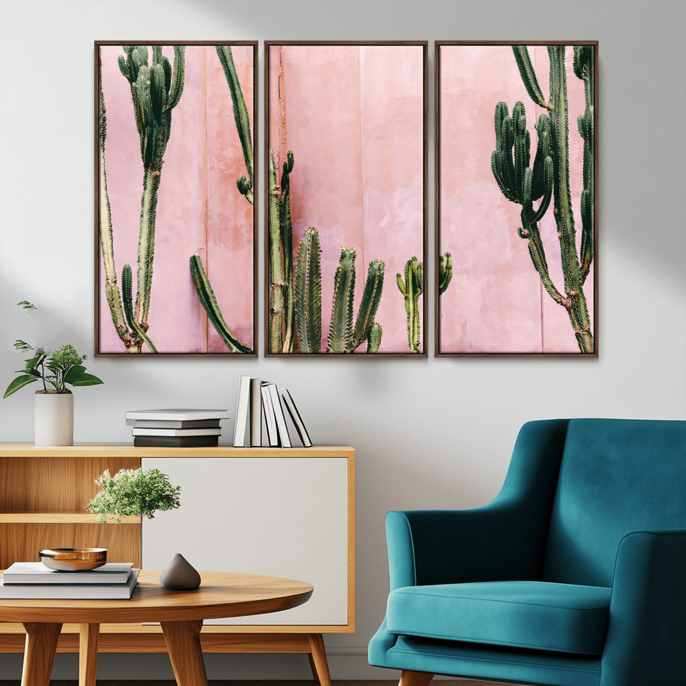 Framed canvas of tall green cacti against a soft pink wall, ideal for modern desert or colorful southwest-inspired home decor.