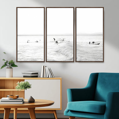 Monochrome photo of surfers riding and waiting on ocean waves, ideal for surf-themed or coastal energy wall decor.