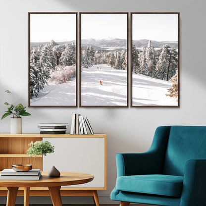 Bright ski trail lined with snow-covered pines and a skier in orange, perfect for alpine adventure or winter sports-inspired decor.