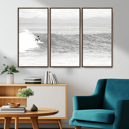 Monochrome photo of a surfer riding a wave with distant mountains, ideal for coastal motion or black and white surf-themed wall decor.