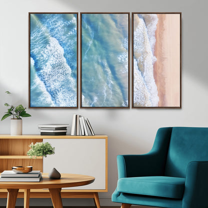 Aerial photo of soft blue waves meeting sandy shore, perfect for modern coastal or beach-themed decor with a light and tranquil aesthetic.