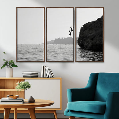 Black and white canvas of two figures cliff jumping into the sea, captured with moody tones, ideal for modern coastal or adventure-themed home decor.   2/2