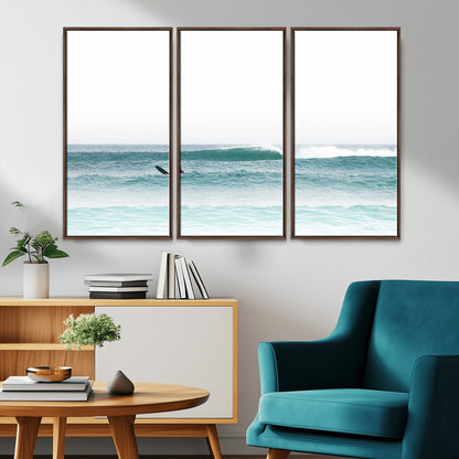 Minimalist photo of a lone surfer on calm aqua waves under bright sky, perfect for Scandinavian coastal or serene ocean-inspired home decor.