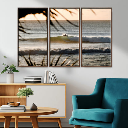 Photo of a surfer riding a golden hour wave at sunset, with tropical tones and dreamy light, perfect for tropical boho or coastal home decor.