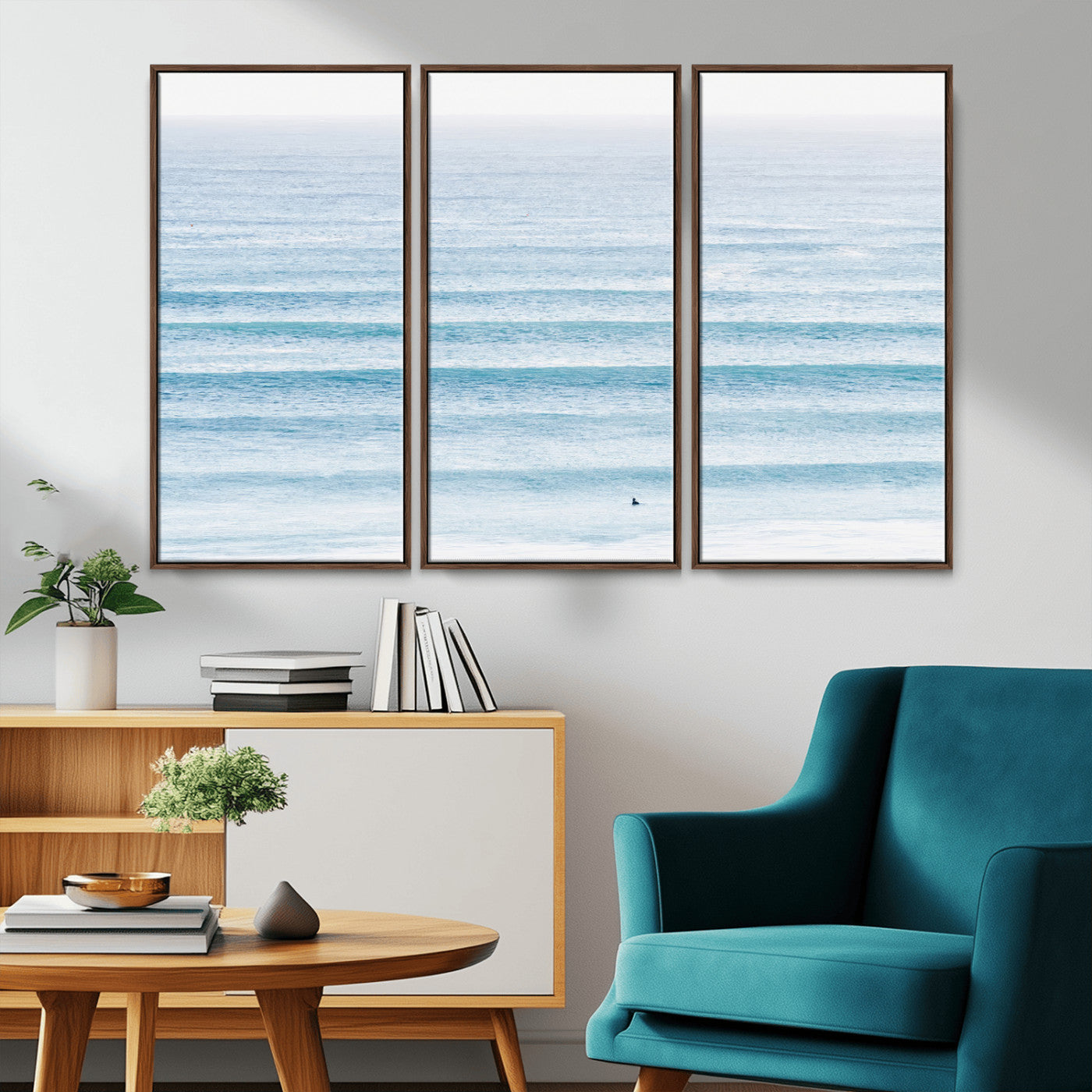 Minimalist ocean view with soft blue waves and a lone surfer, creating a serene and airy coastal aesthetic, perfect for tranquil home decor.