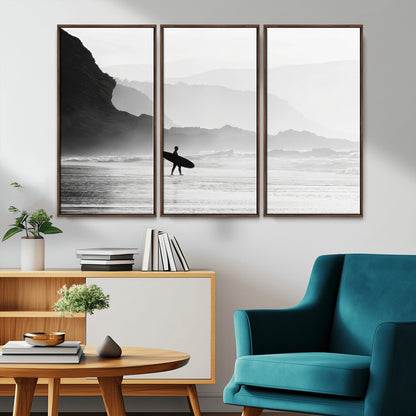 A lone surfer walking along a misty beach with cliffs in the background, carrying their board, capturing a serene and minimal ocean moment.