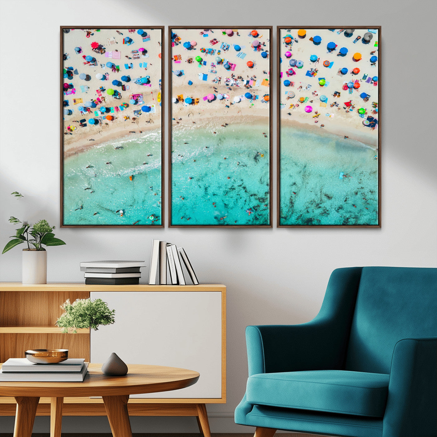Aerial view of a vibrant beach filled with colorful umbrellas and people enjoying the turquoise ocean, capturing a lively summer vacation scene.