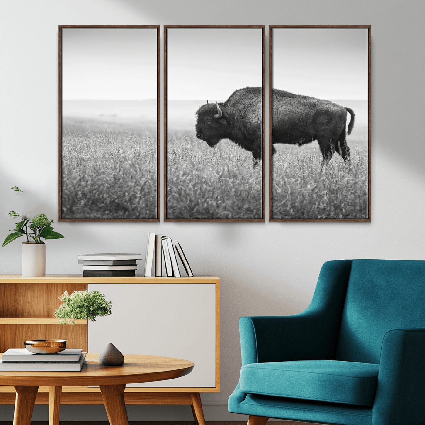 A black and white photograph of a majestic bison standing in a vast grassy prairie, evoking a sense of wilderness and strength.
