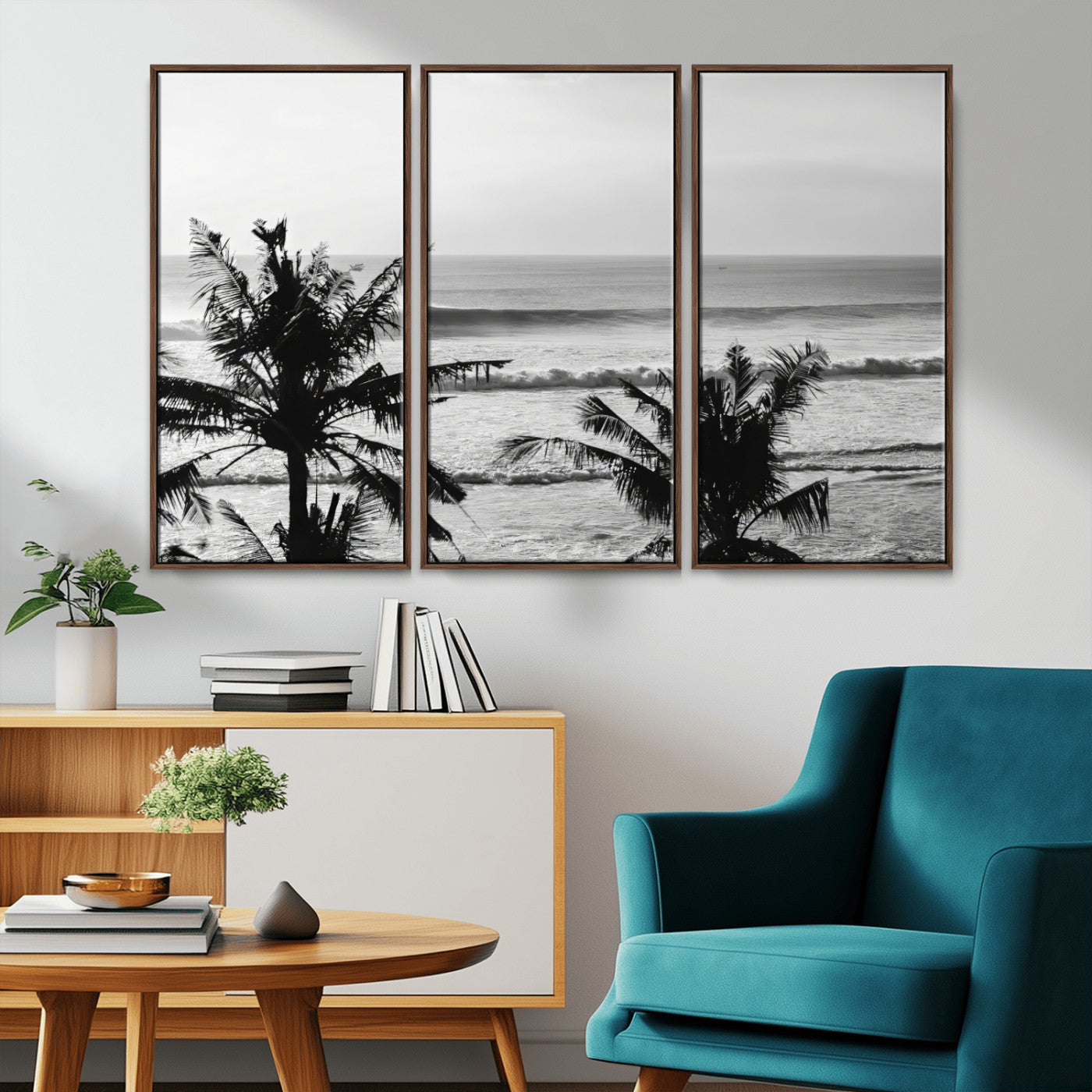 Black and white view of ocean waves crashing on a tropical coastline, framed by silhouetted palm trees under a vast, open sky.