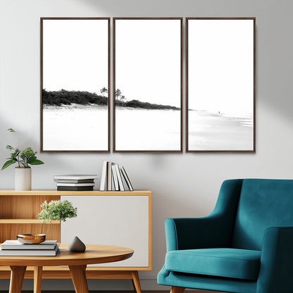 A black and white minimalist coastal scene with a vast open beach, distant palm trees, and a lone figure walking along the shoreline, evoking serenity and solitude.