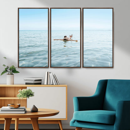 A peaceful minimalist scene of a person floating on crystal-clear water, surrounded by a vast open horizon, capturing relaxation and serenity in a tranquil aquatic setting.