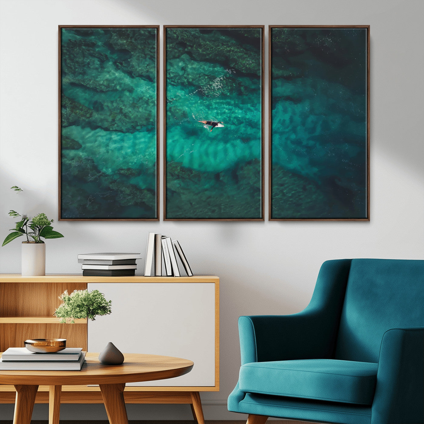 An aerial view of a solo surfer paddling through crystal-clear turquoise waters over a sunlit reef, capturing the beauty and serenity of open water surfing.