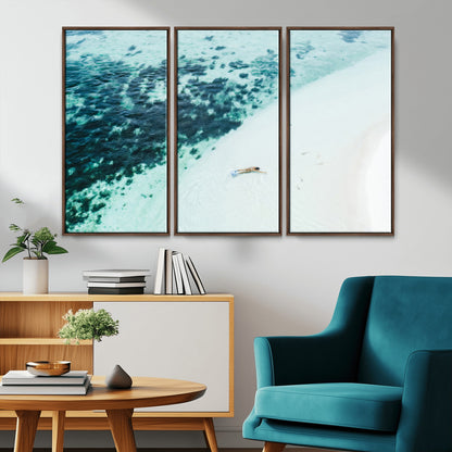 Canvas featuring an aerial view of a swimmer in shallow turquoise waters with coral patterns, ideal for tropical coastal home decor.