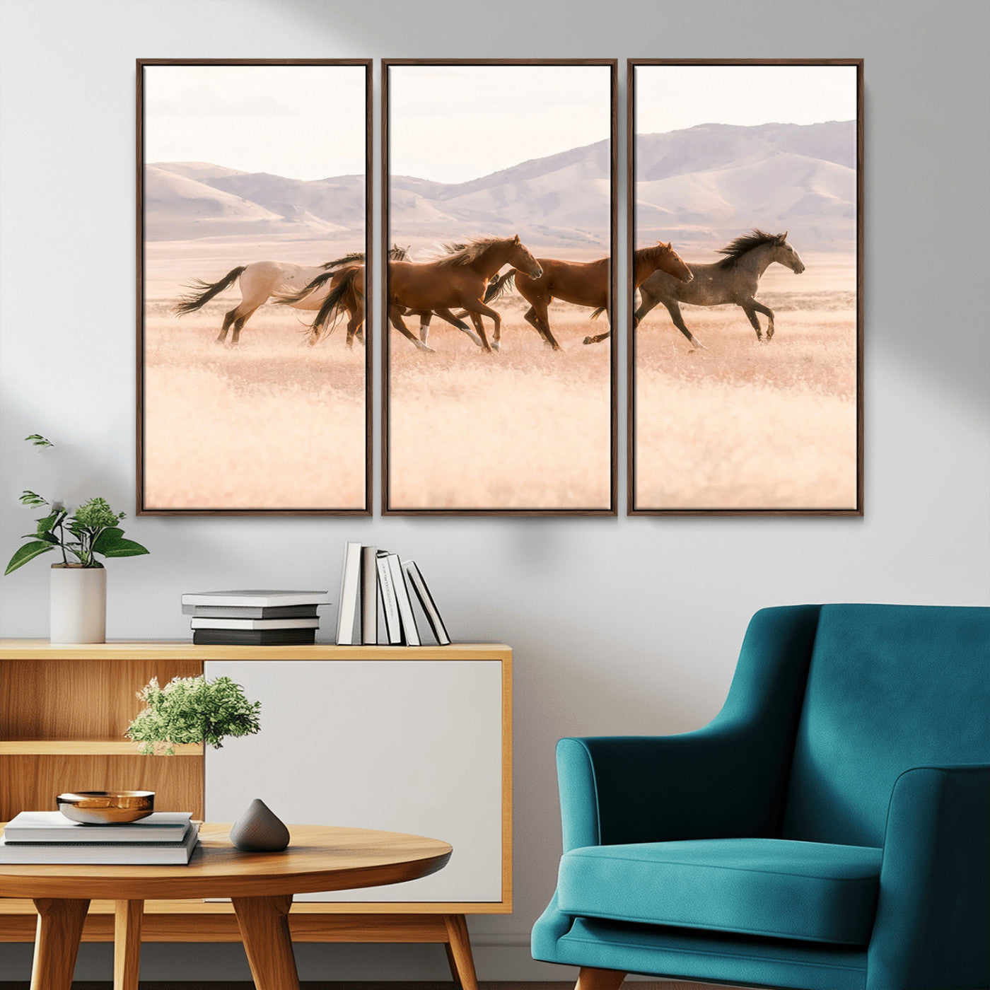A herd of wild horses galloping through a sunlit desert plain with mountains in the background, perfect for rustic or western-themed wall decor.