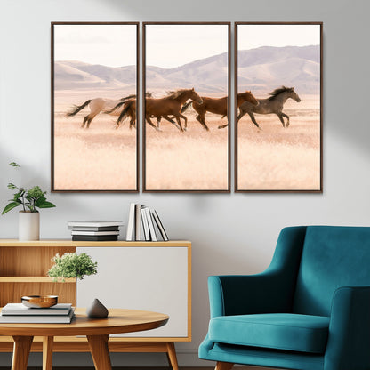 A herd of wild horses galloping through a sunlit desert plain with mountains in the background, perfect for rustic or western-themed wall decor.