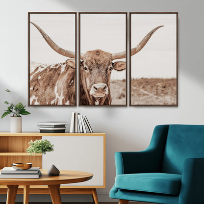 A longhorn cow in soft beige desert tones, standing calmly in open land, perfect for neutral western or rustic farmhouse interiors.