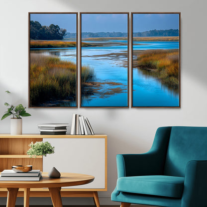 A peaceful marshland scene with calm blue water reflecting the surrounding grasses and trees, capturing the beauty of nature in a serene landscape.