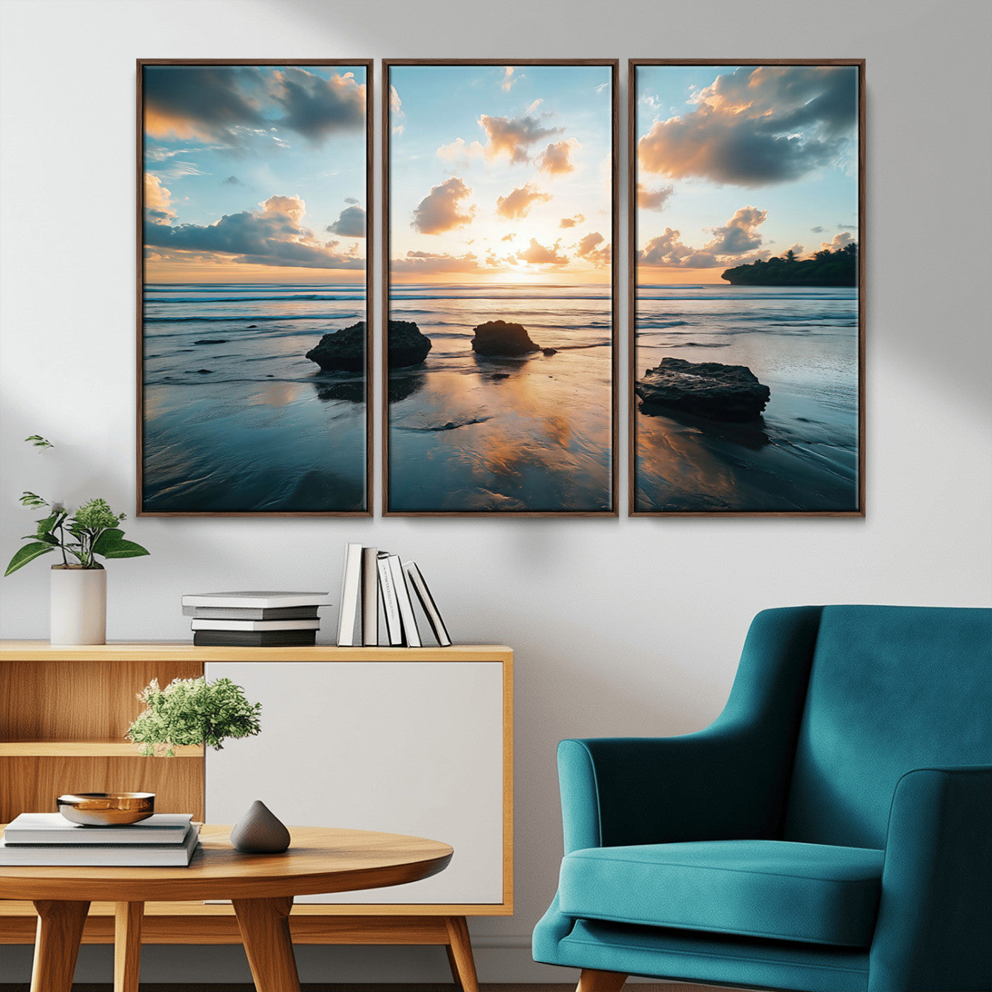 A serene beach at sunset with vibrant clouds, calm water, and rocks in the foreground reflecting the warm colors of the setting sun.