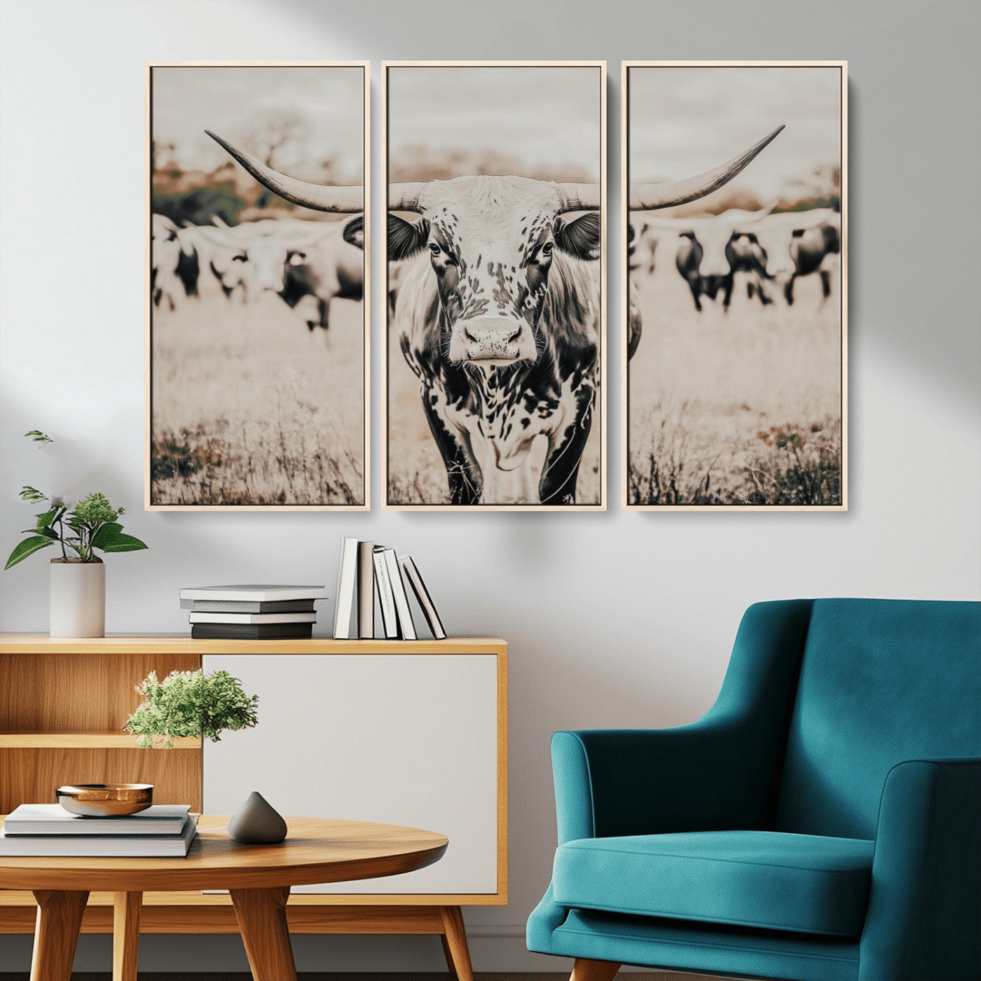 Canvas of a speckled Texas longhorn standing boldly in a field with a herd behind, perfect for rustic western or farmhouse wall decor.