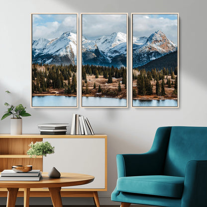 Framed canvas of snowy mountain peaks with pine forest and alpine lake, perfect for winter cabin or wilderness-inspired home decor.