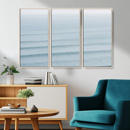 Framed canvas of repeating ocean waves with a distant solo surfer, ideal for minimalist ocean or calm coastal wall decor.