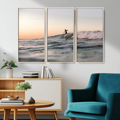 Framed canvas of a female surfer balancing on a wave at sunset, perfect for serene surf or ocean-inspired coastal decor.