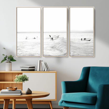 Monochrome photo of surfers riding and waiting on ocean waves, ideal for surf-themed or coastal energy wall decor.