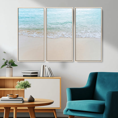Soft shoreline with gentle aqua waves on smooth sand, ideal for minimalist coastal or pastel ocean-inspired home wall decor.
