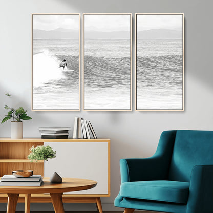 Monochrome photo of a surfer riding a wave with distant mountains, ideal for coastal motion or black and white surf-themed wall decor.