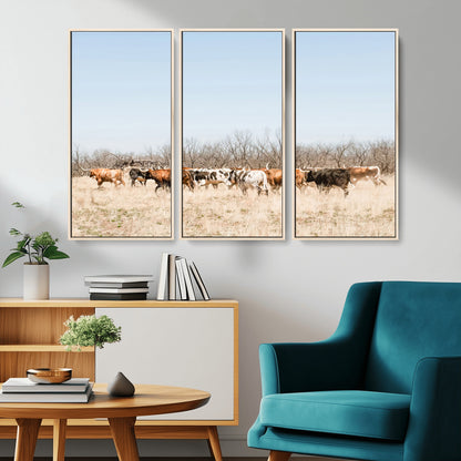 Framed wall art of Texas longhorn cattle walking through a dry, neutral-toned prairie, perfect for rustic farmhouse or western-themed home decor.