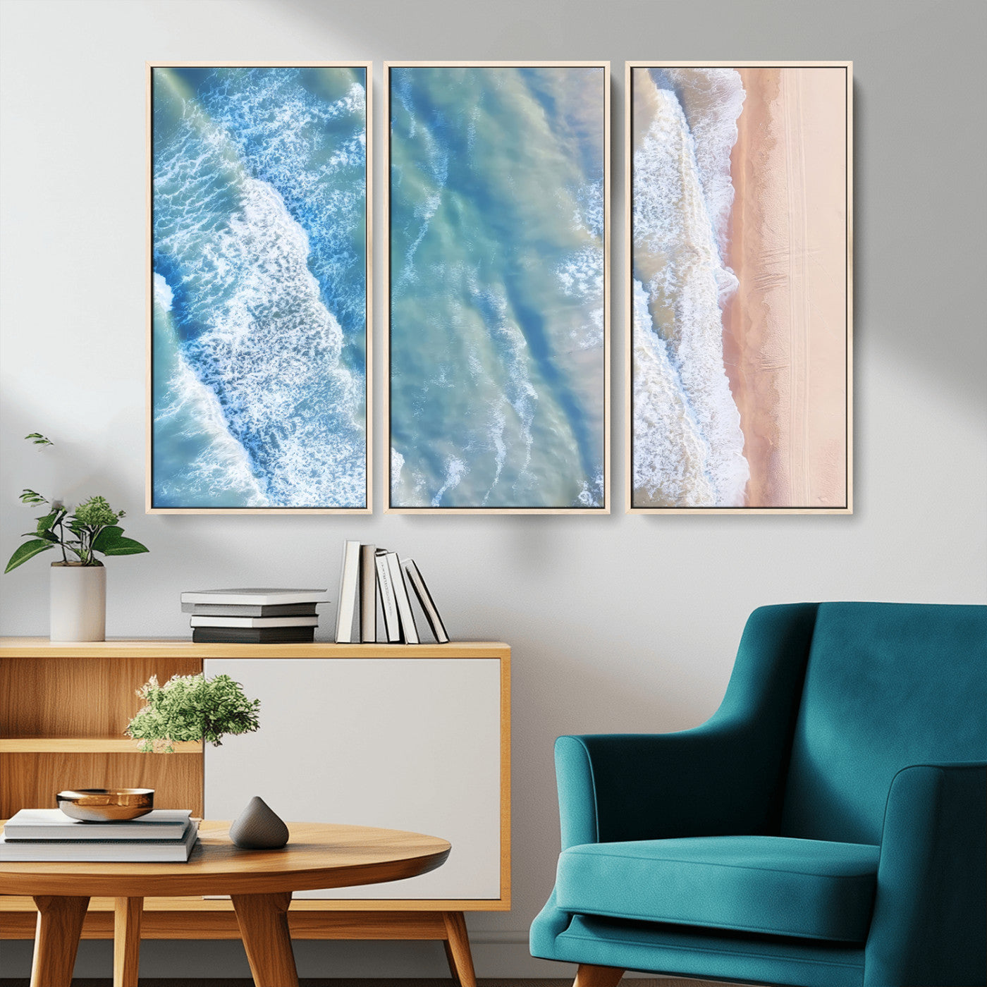 Aerial photo of soft blue waves meeting sandy shore, perfect for modern coastal or beach-themed decor with a light and tranquil aesthetic.