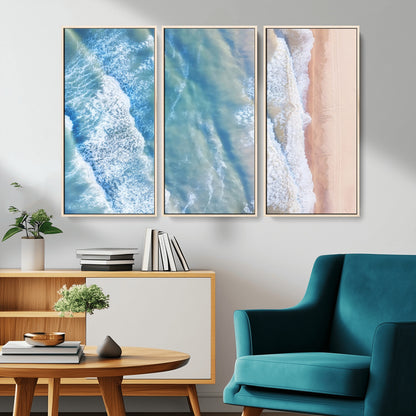 Aerial photo of soft blue waves meeting sandy shore, perfect for modern coastal or beach-themed decor with a light and tranquil aesthetic.