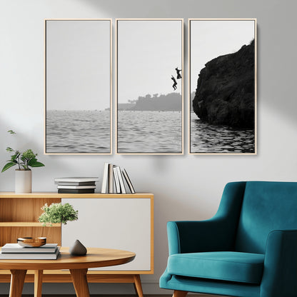 Black and white canvas of two figures cliff jumping into the sea, captured with moody tones, ideal for modern coastal or adventure-themed home decor.   2/2