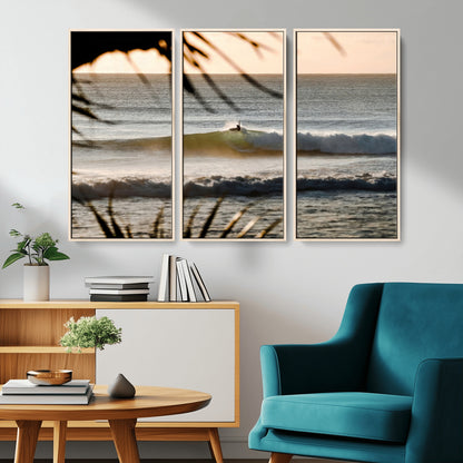 Photo of a surfer riding a golden hour wave at sunset, with tropical tones and dreamy light, perfect for tropical boho or coastal home decor.