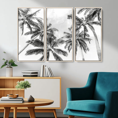 Black and white tropical palm trees viewed from below, swaying gently against a bright sky, creating a serene and elegant coastal atmosphere.
