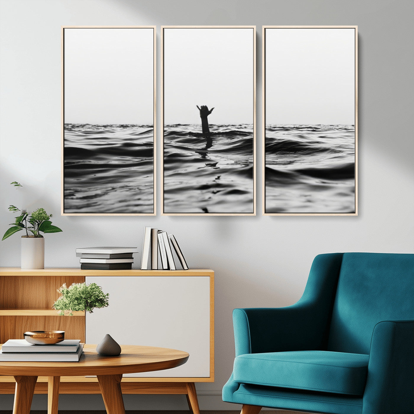 Black and white ocean with a hand making a surfer sign among dark waves, creating a dramatic and minimalist seascape with bold contrast.