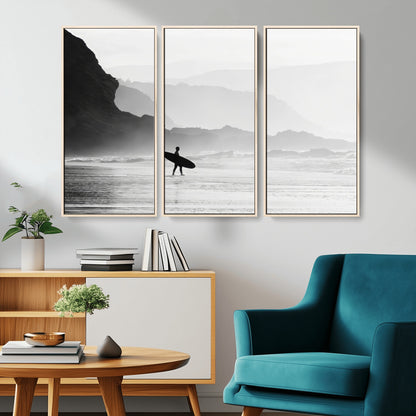 A lone surfer walking along a misty beach with cliffs in the background, carrying their board, capturing a serene and minimal ocean moment.