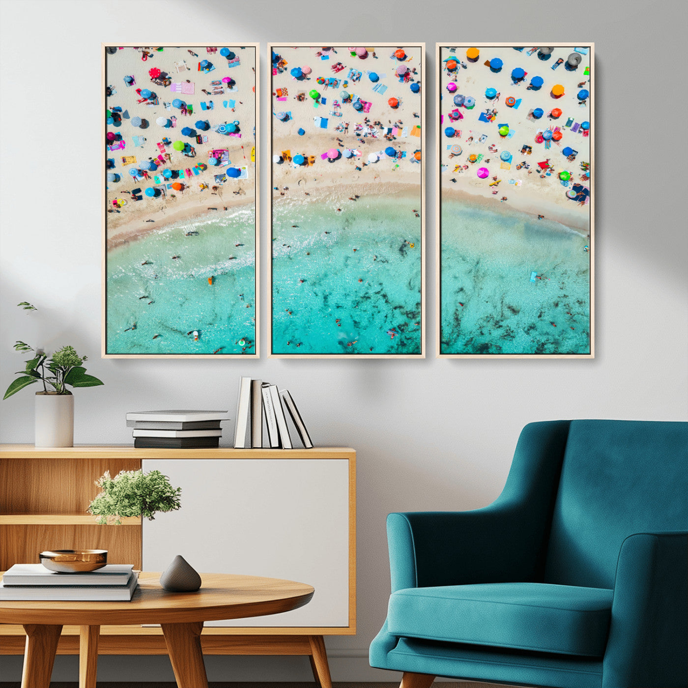 Aerial view of a vibrant beach filled with colorful umbrellas and people enjoying the turquoise ocean, capturing a lively summer vacation scene.