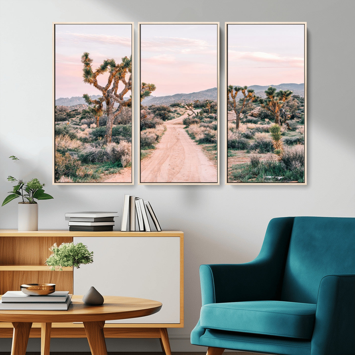A dusty road winding through Joshua Tree National Park, framed by iconic twisted trees and warm desert tones under a soft pastel sky.