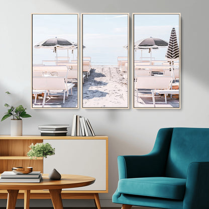 A serene minimalist beach scene featuring striped umbrellas, soft pastel sand, and an elegant lounge setup, creating a tranquil and stylish coastal retreat.