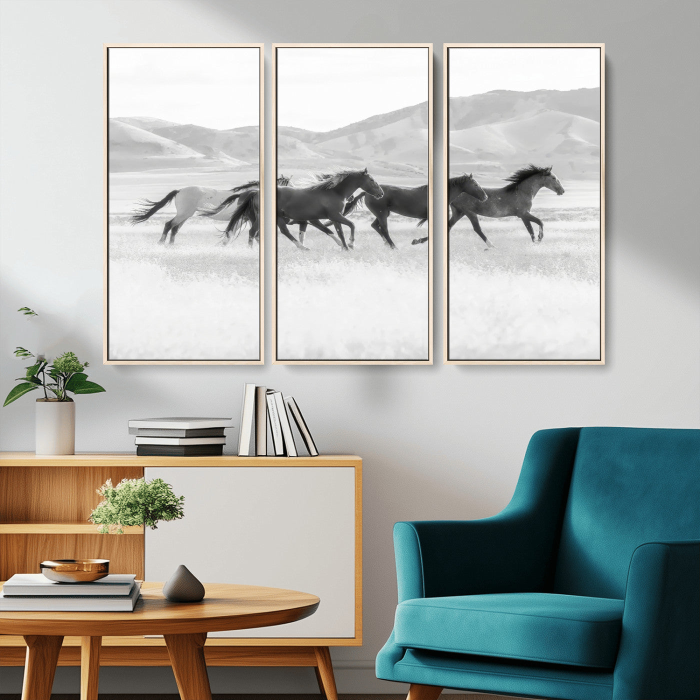 A black and white image of wild horses running freely across an open grassland, capturing the power and beauty of untamed nature in a rustic western setting.
