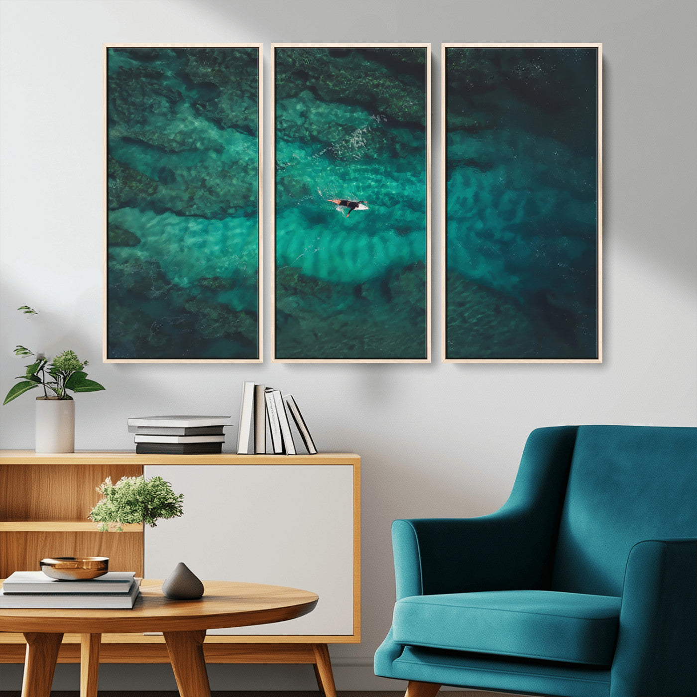 An aerial view of a solo surfer paddling through crystal-clear turquoise waters over a sunlit reef, capturing the beauty and serenity of open water surfing.