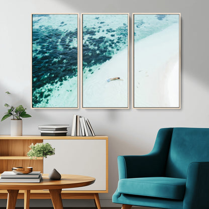 Canvas featuring an aerial view of a swimmer in shallow turquoise waters with coral patterns, ideal for tropical coastal home decor.