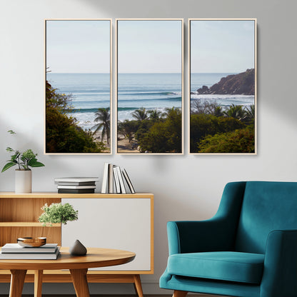 View of calm ocean waves with palm trees and a tropical coastline, ideal for coastal boho or beach-themed wall decor.